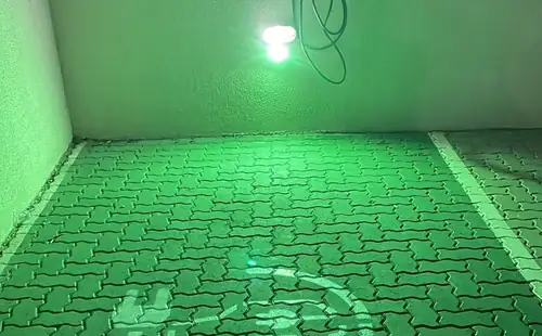 Vaga de recarga elétrica PowerUp iluminada à noite em condomínio